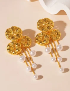 Gold floral drop earrings with pearl accents for women on a clean product background.