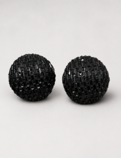 Black rhinestone semi round stud earrings for women with a dome design on a light background