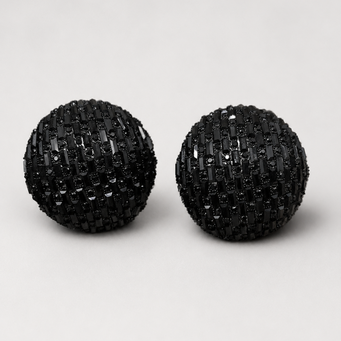 Black rhinestone semi round stud earrings for women with a dome design on a light background